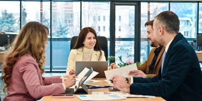 Business meeting in an office, workers discussing business affairs. Gadgets and papers on the table